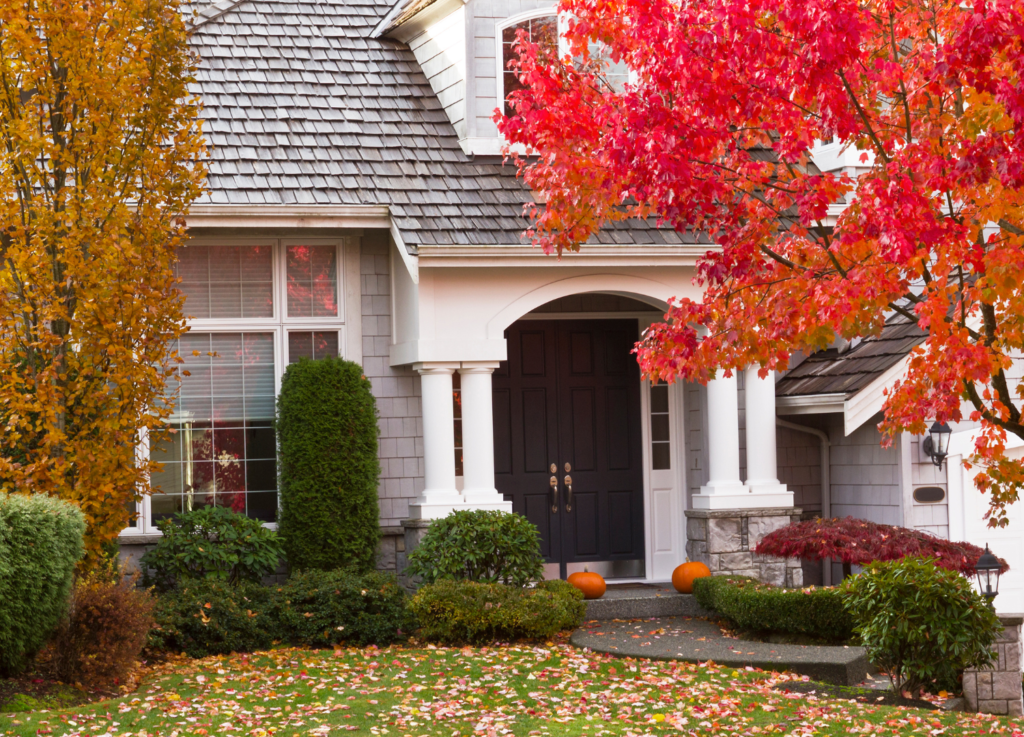 this image of a house in fall shows a roof that has been repaired or replaced in fall - a time of year that is often seen as best for roof work